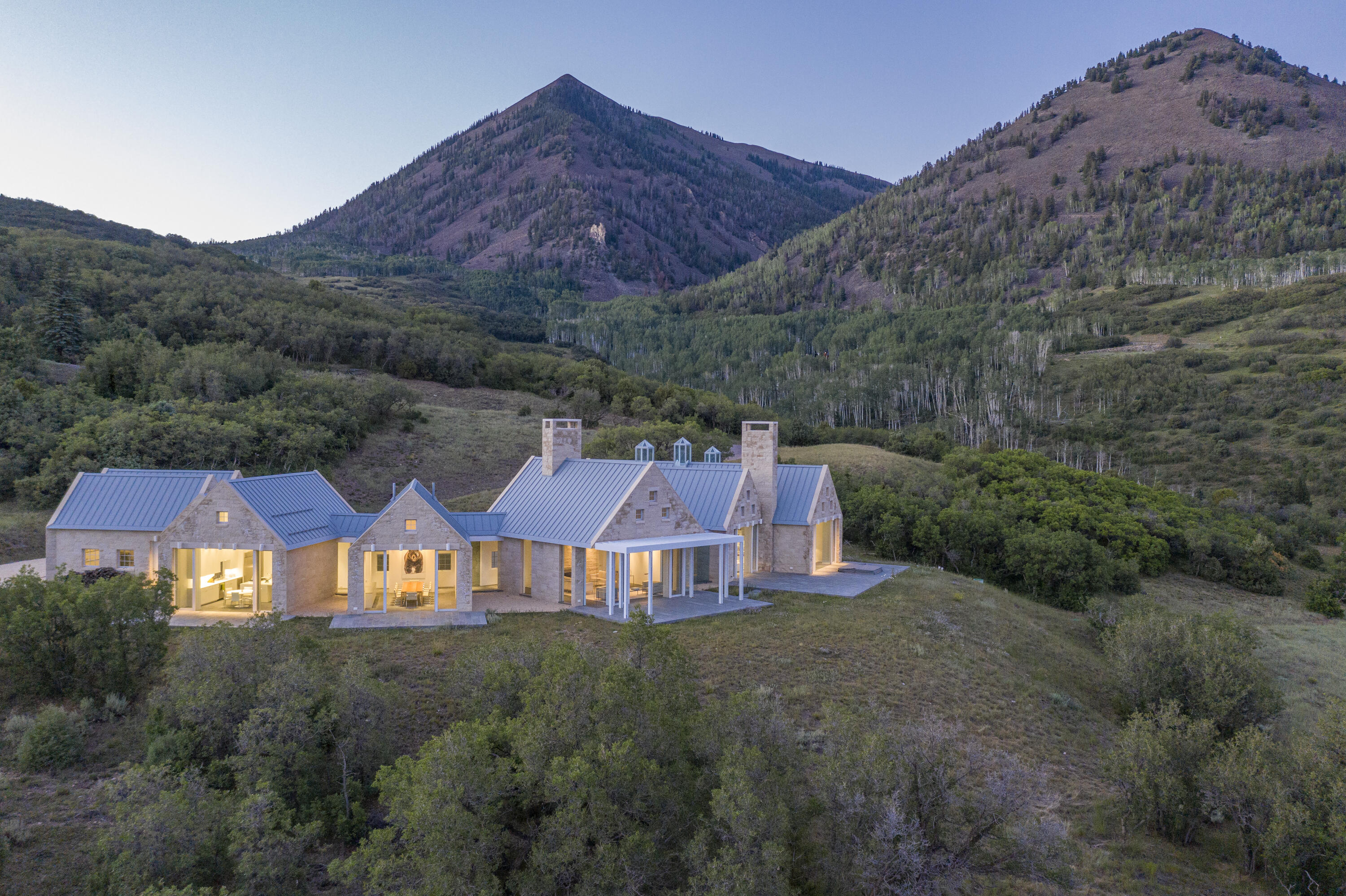 1068 Wilson Way Telluride, CO 81435 - Photo 16 of 40 an aerial view of a house around side of green landscape
