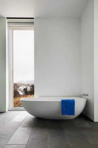 a bathroom with a bathtub and window