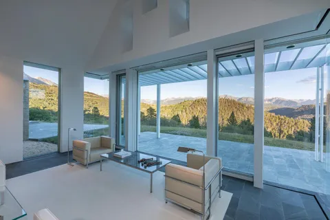 a living room with furniture and a floor to ceiling window
