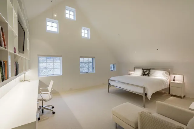 a bedroom with furniture and a window