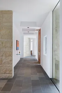 a view of a hallway with wooden shelves