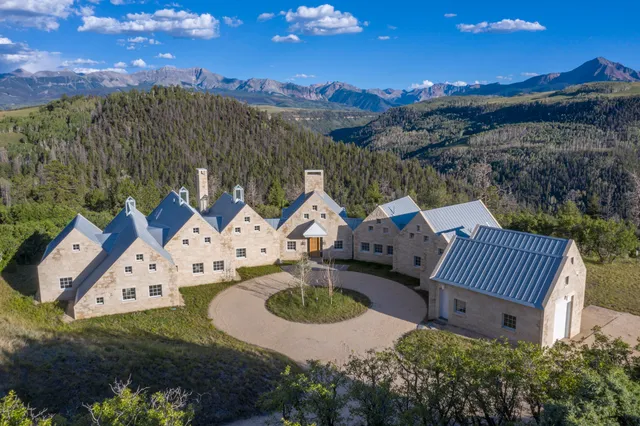 an aerial view of a house with garden space and street view