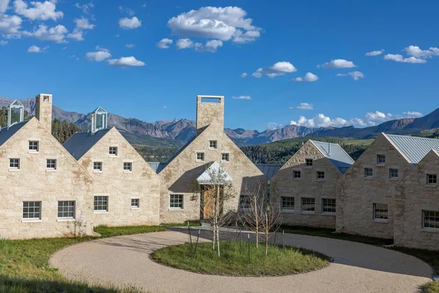 a front view of a house with a yard and outdoor seating
