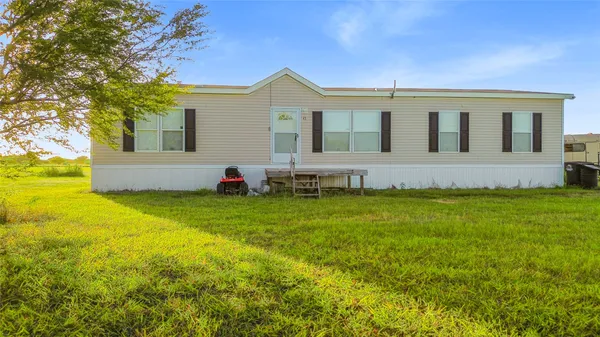 a view of house with backyard and garden