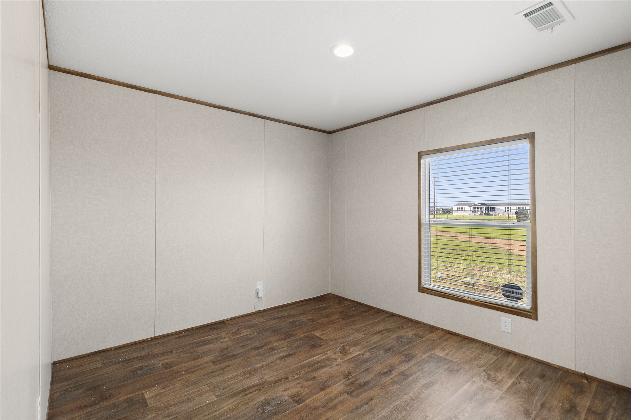 43 Ironwood Road Victoria, TX 77904 - Photo 10 of 21 an empty room with wooden floor and windows