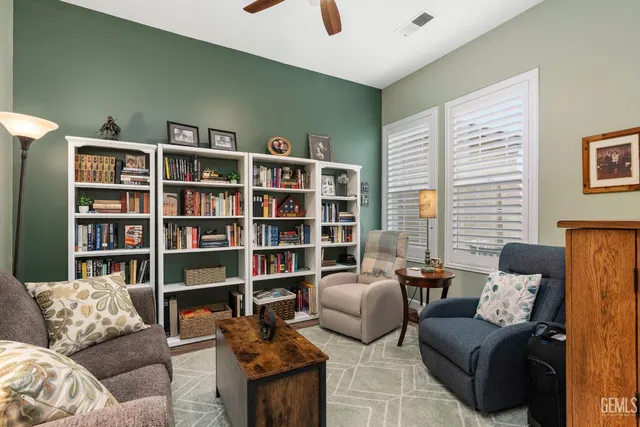 a living room with furniture and a book shelf
