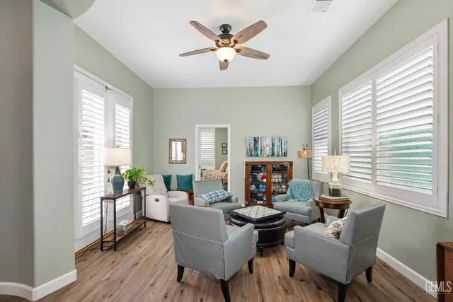 a living room with furniture fireplace and a large window