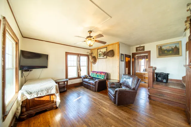 a bedroom with furniture and a wooden floor