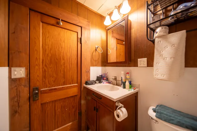 a bathroom with a sink a toilet and a mirror