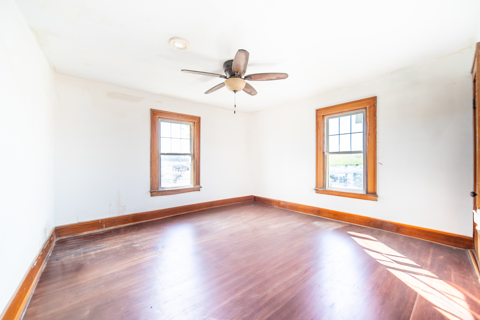 1801 Lee Center Road Amboy, IL 61310 - Photo 28 of 45 a view of an empty room with a window and wooden floor