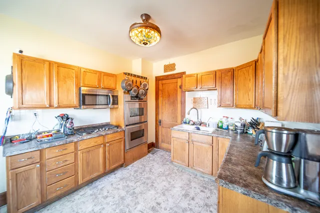 a kitchen with a sink a stove and cabinets