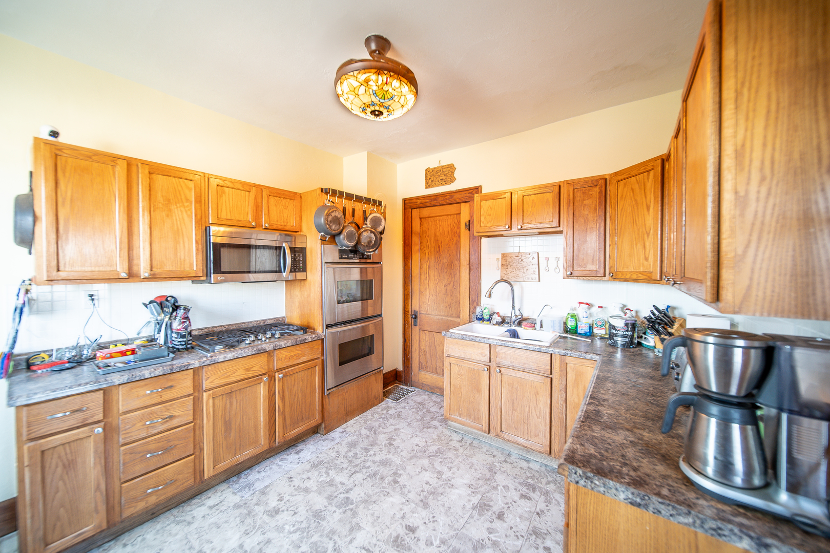 1801 Lee Center Road Amboy, IL 61310 - Photo 3 of 45 a kitchen with a sink a stove and cabinets