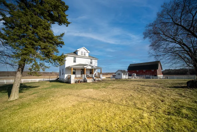 a view of a house with backyard and lake view