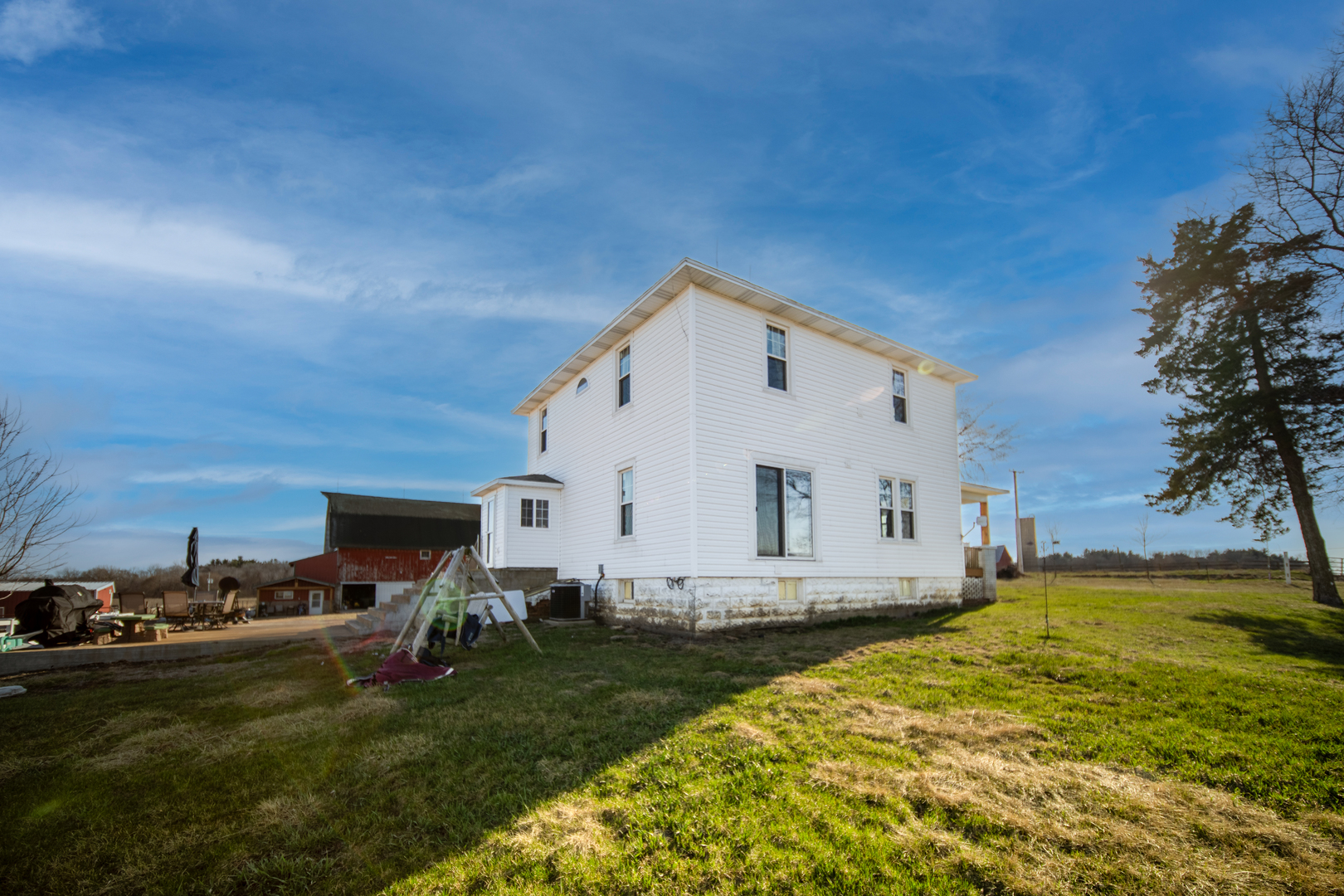 1801 Lee Center Road Amboy, IL 61310 - Photo 33 of 45 a view of a white house with garden and yard