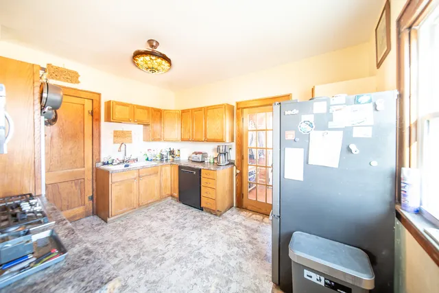 a kitchen with a refrigerator and countertop