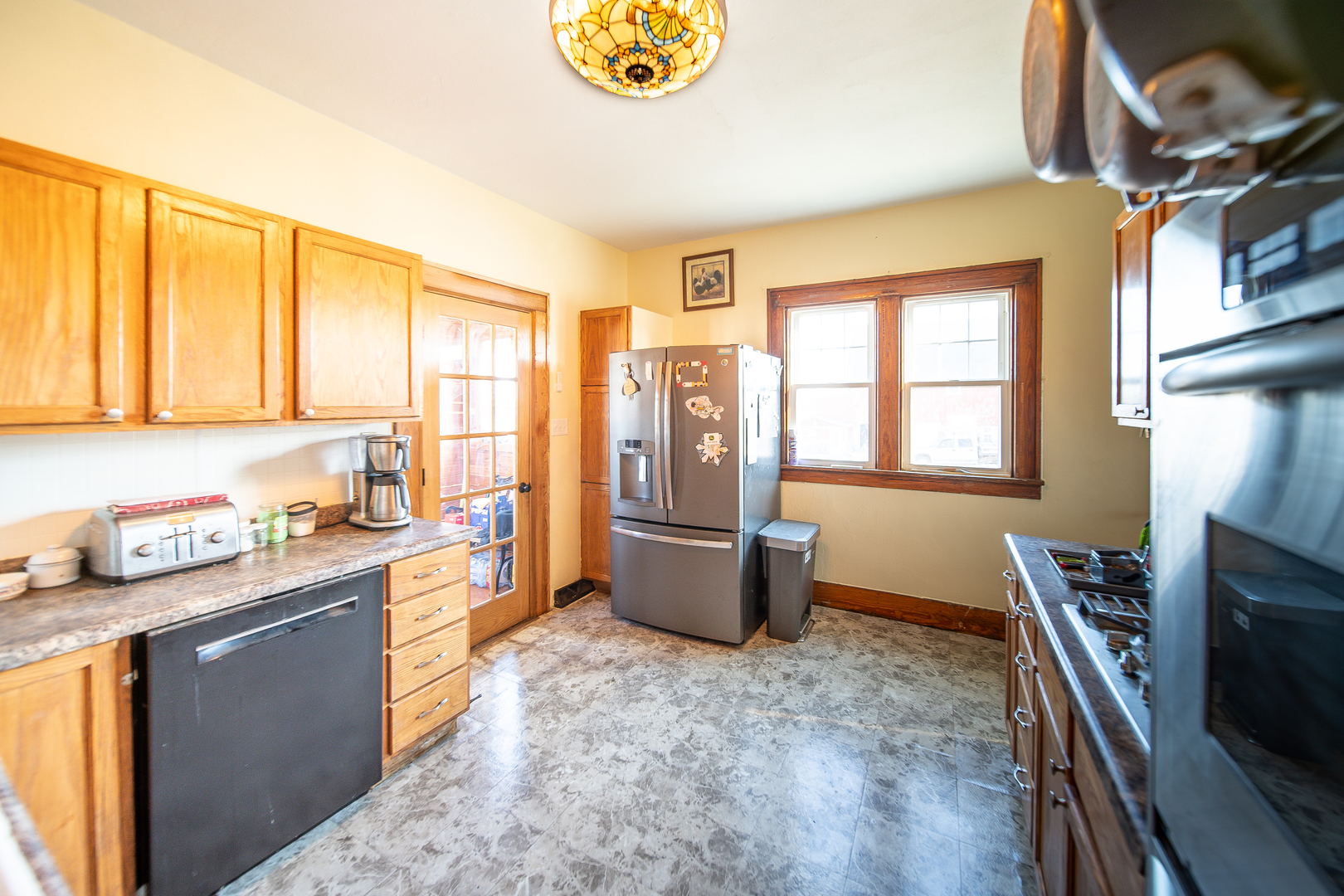 1801 Lee Center Road Amboy, IL 61310 - Photo 6 of 45 a kitchen with stainless steel appliances granite countertop a stove top oven a sink a dining table and chairs with wooden floor