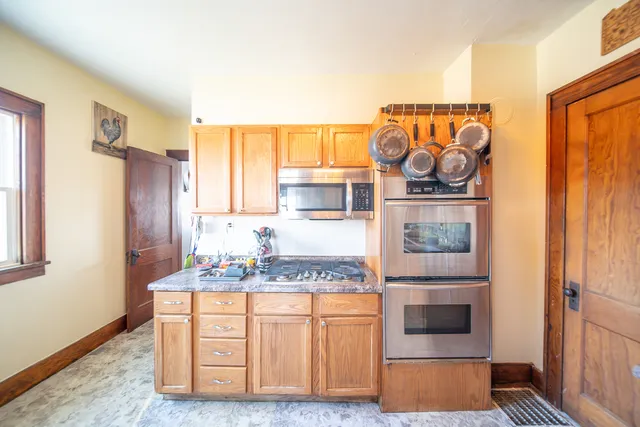 a kitchen with stainless steel appliances granite countertop a stove and a refrigerator