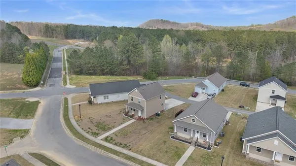 an aerial view of a house with a mountain