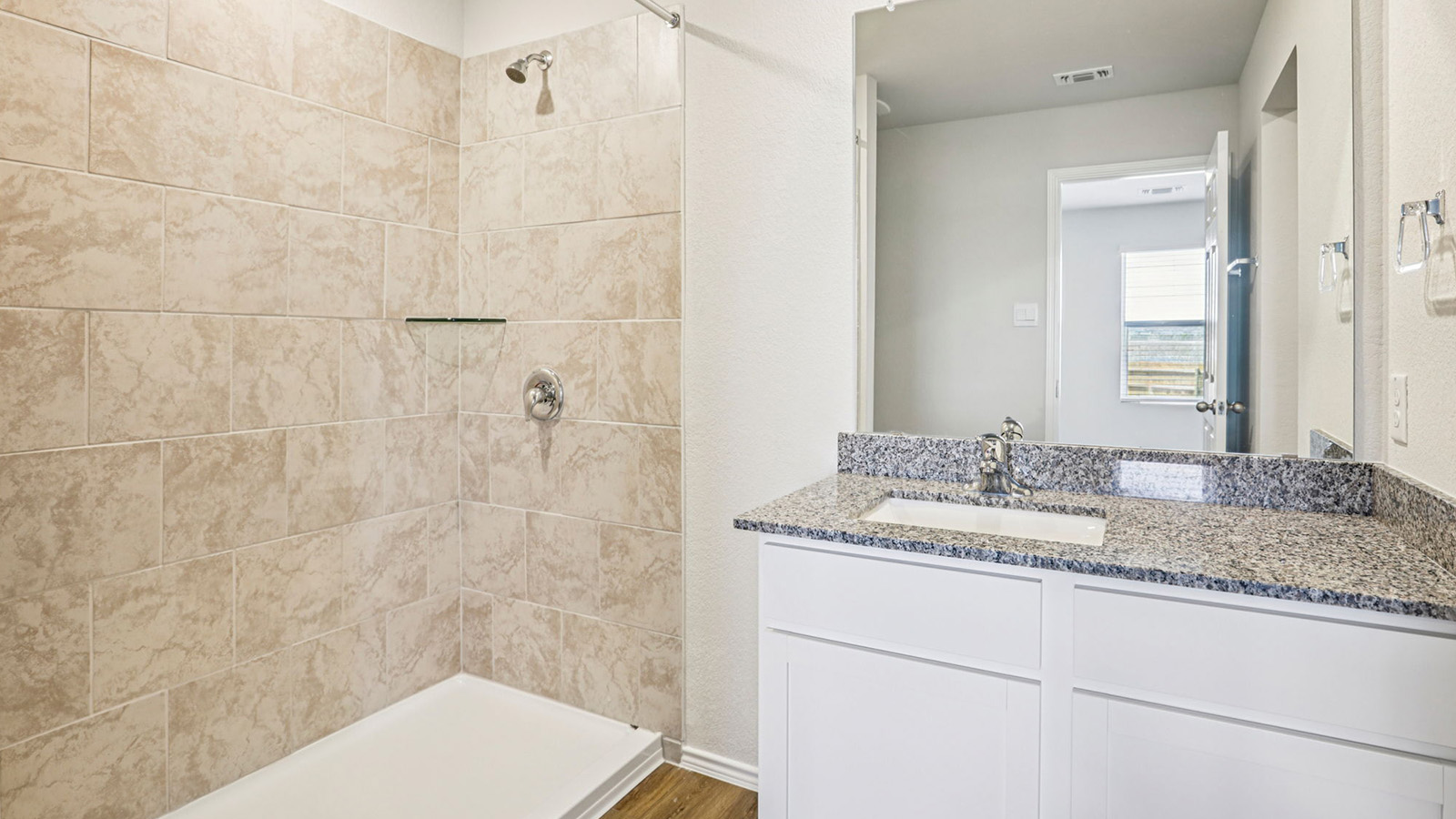 148 Wyatt Way Jarrell, TX 76537 - Photo 20 of 33 Bathroom featuring a white vanity with a granite countertop, undermount sink, and a framed mirror