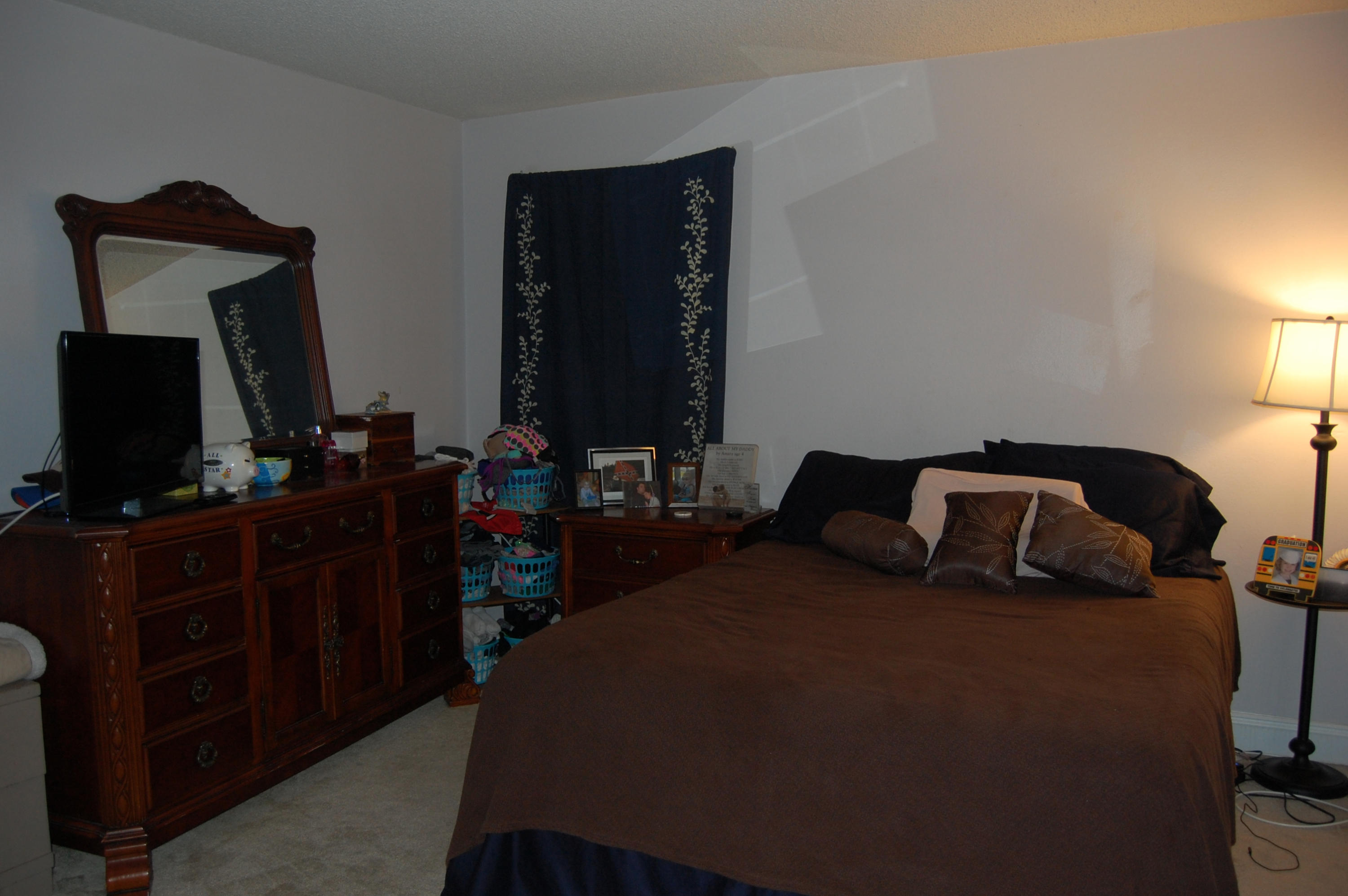210 Pelham Road, Unit 206C Fort Walton Beach, FL 32547 - Photo 11 of 11 a bedroom with a bed and a flat tv screen on dresser
