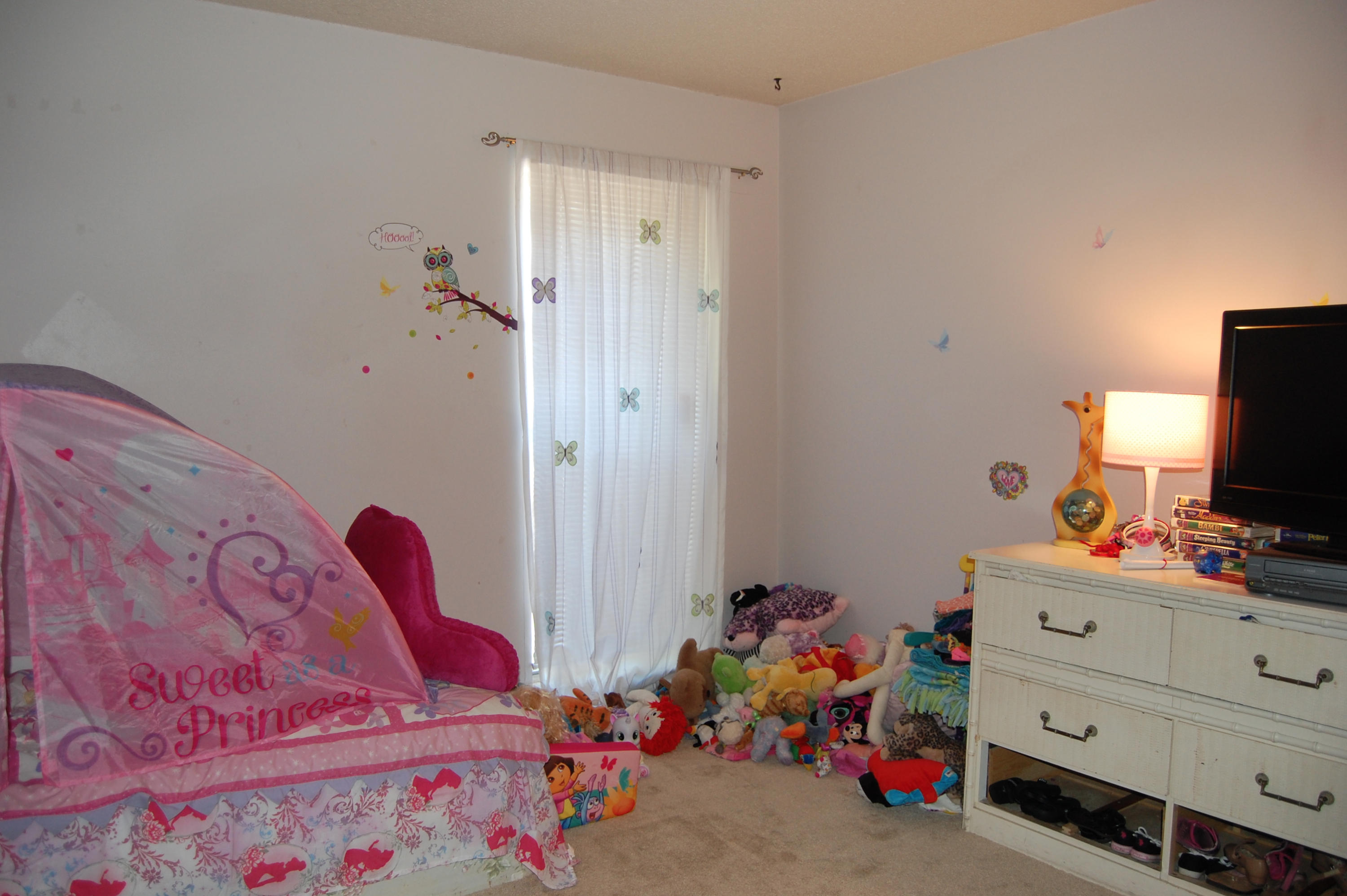 210 Pelham Road, Unit 206C Fort Walton Beach, FL 32547 - Photo 6 of 11 a bedroom with a bed and a dresser