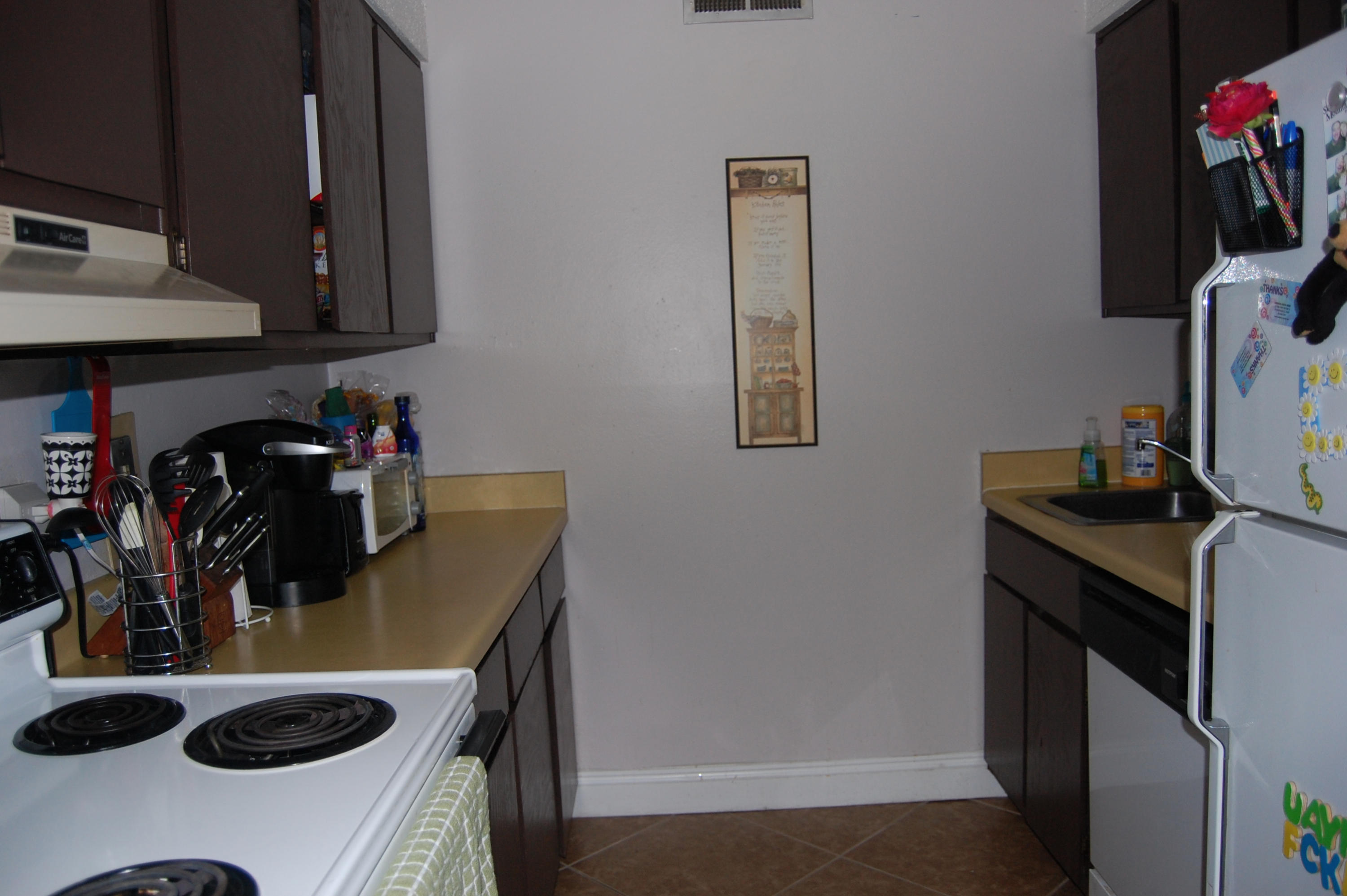210 Pelham Road, Unit 206C Fort Walton Beach, FL 32547 - Photo 10 of 11 a kitchen with a sink a stove and a microwave
