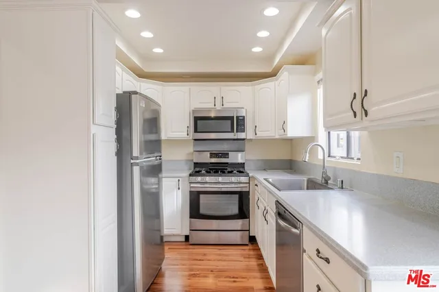 a kitchen with stainless steel appliances granite countertop a stove and a sink