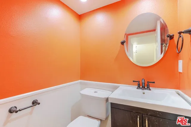 a bathroom with a sink mirror and vanity