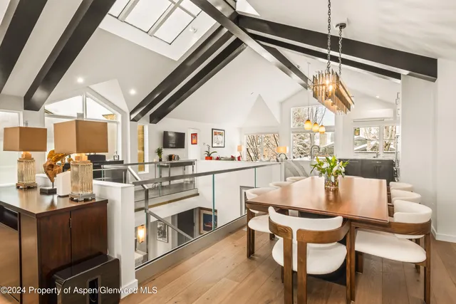 a dining room with furniture and wooden floor