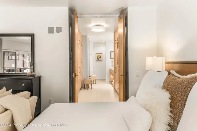 a bedroom with a bed and a mirror