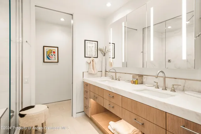 a bathroom with a double vanity sink mirror and