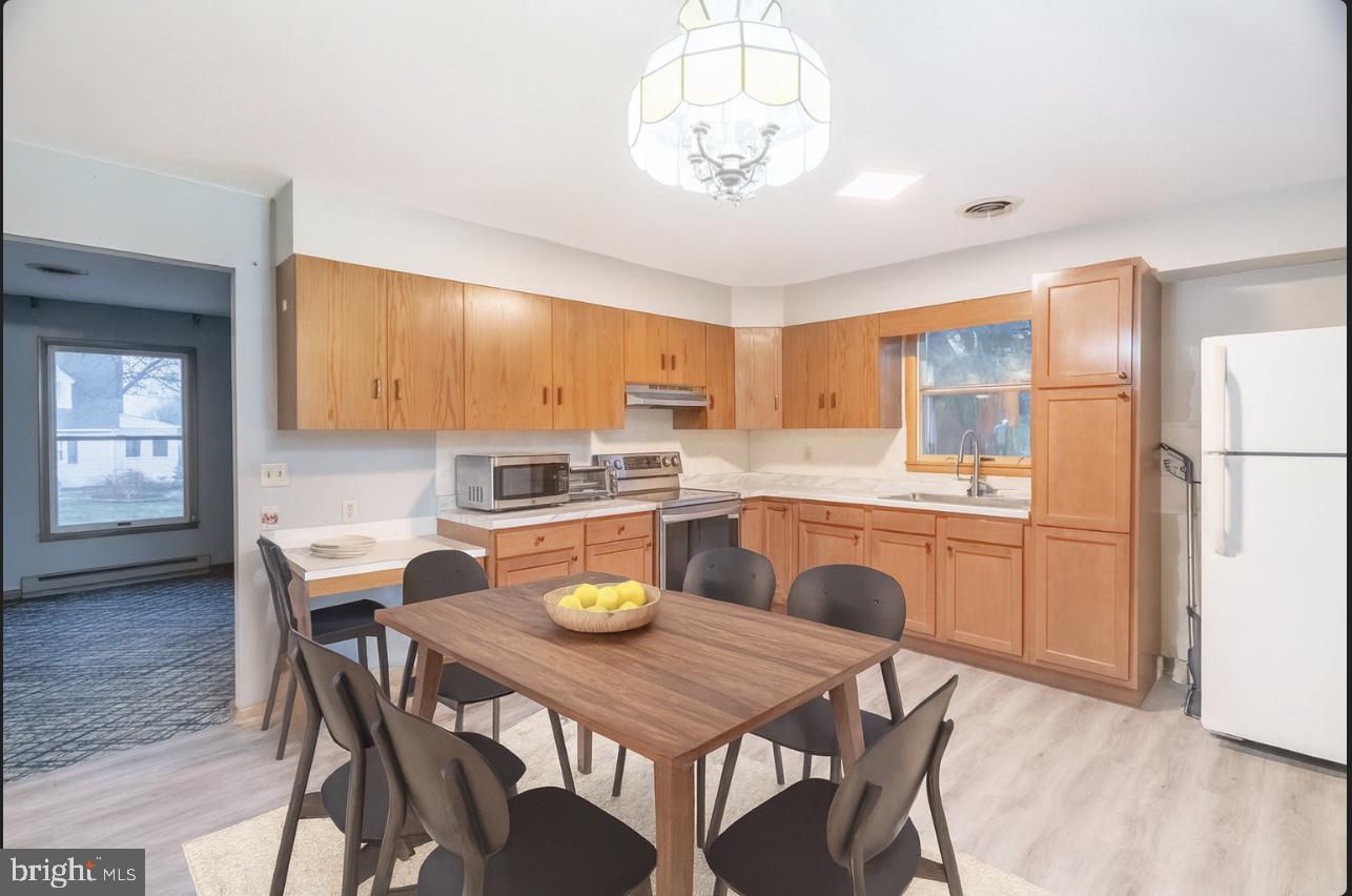 17511 Gay Street Hagerstown, MD 21740 - Photo 6 of 30 a kitchen with a dining table chairs and refrigerator