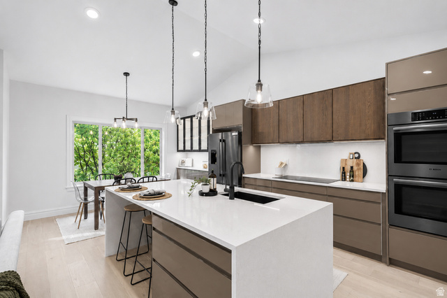 1429 Chateau Ridge Way Sandy, UT 84092 - Photo 5 of 22 Kitchen island with a white countertop and integrated sink