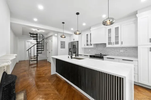 a kitchen with a sink stainless steel appliances and cabinets
