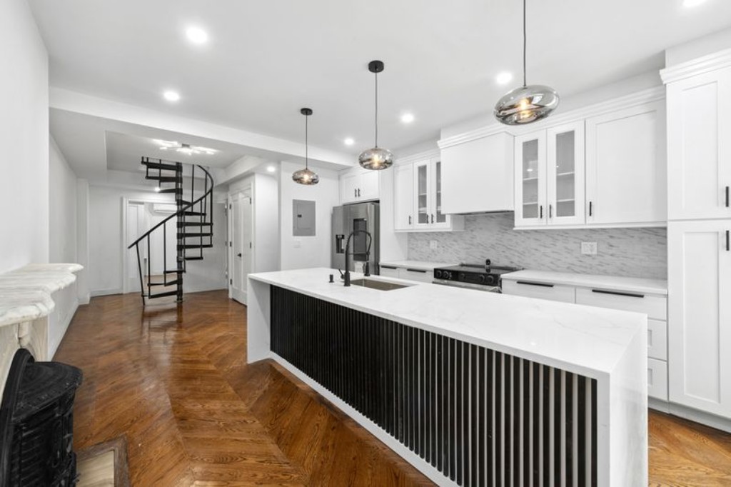 a kitchen with a sink stainless steel appliances and cabinets