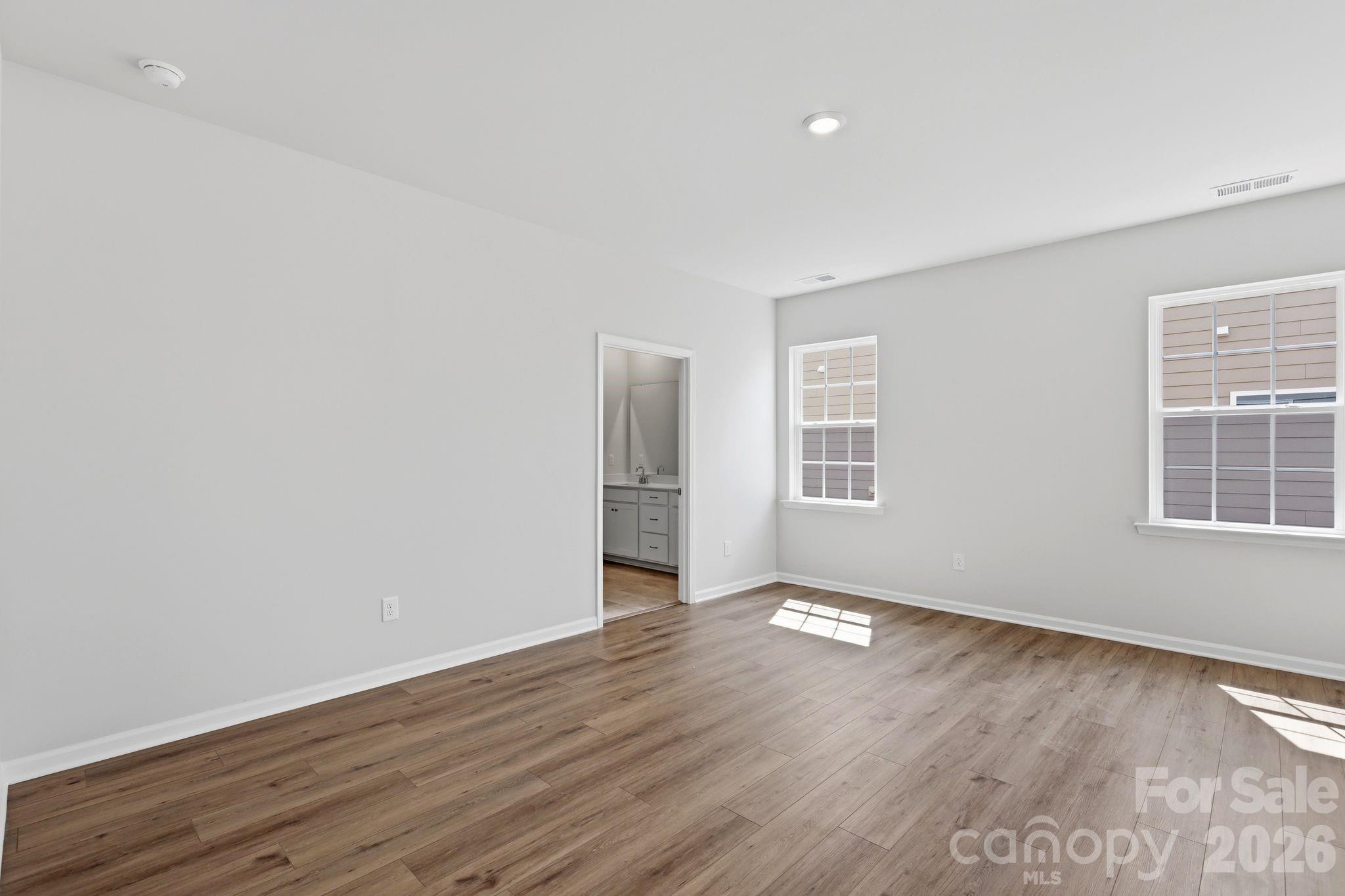5475 Redbud Road, Unit 57 Lancaster, SC 29720 - Photo 23 of 30 a view of an empty room with wooden floor and a window