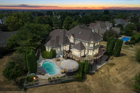 an aerial view of a house with a yard basket ball court and outdoor seating