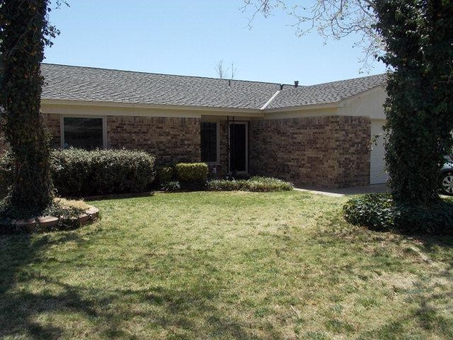 3409 84th Street Lubbock, TX 79423 - Photo 2 of 10 a front view of a house with a yard