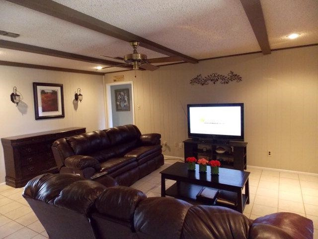 3409 84th Street Lubbock, TX 79423 - Photo 4 of 10 a living room with furniture and a flat screen tv