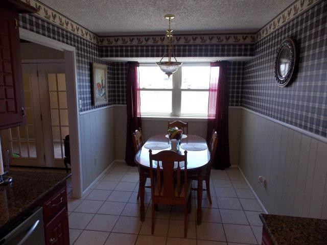 3409 84th Street Lubbock, TX 79423 - Photo 5 of 10 a view of a dining room with furniture and chandelier