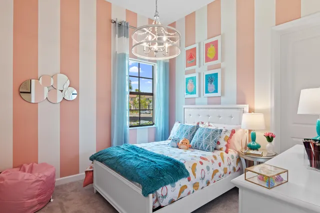 a dining room with granite countertop lots of white furniture and a chandelier