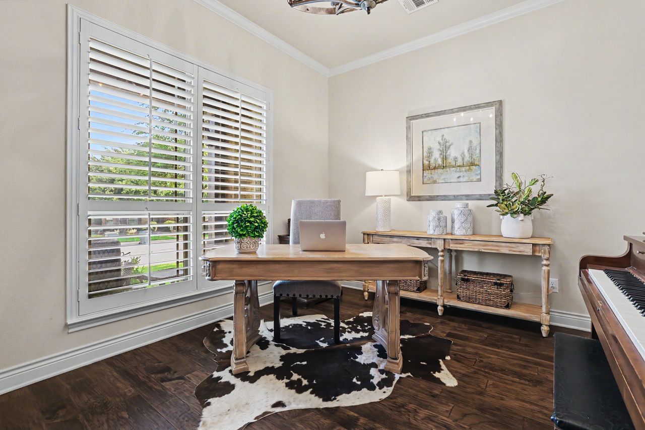 809 Prairie Dunes Drive Georgetown, TX 78628 - Photo 5 of 40 A refined home office offers rich hardwood floors and abundant natural light for focused work.