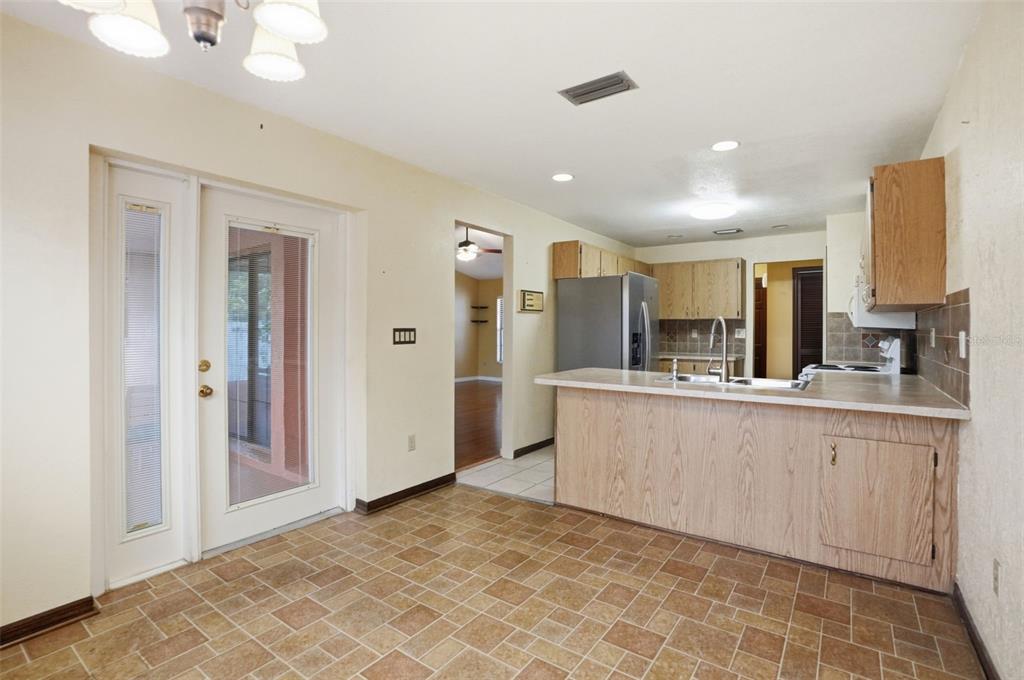 11286 Roland Street Spring Hill, FL 34609 - Photo 18 of 54 a large white kitchen with a sink and refrigerator