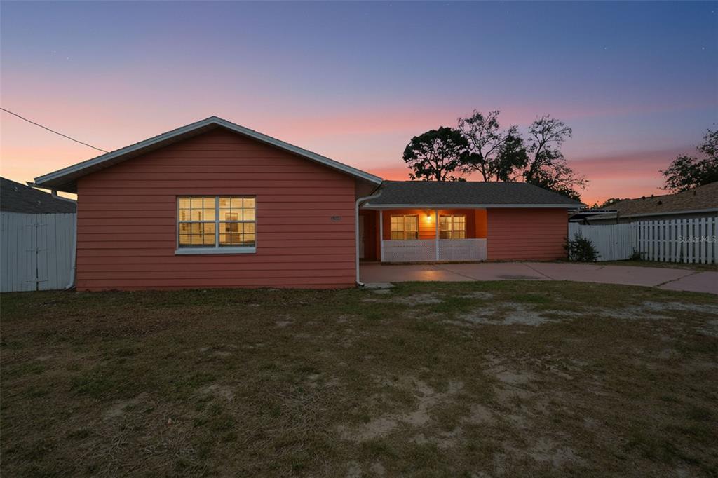 11286 Roland Street Spring Hill, FL 34609 - Photo 2 of 54 a front view of a house with a garden