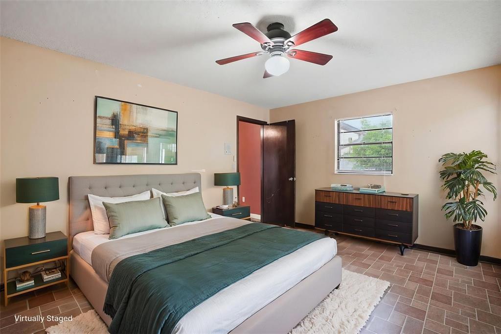 11286 Roland Street Spring Hill, FL 34609 - Photo 24 of 54 a bedroom with a bed and a chandelier