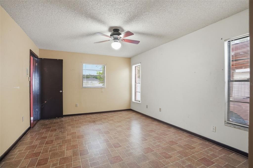 11286 Roland Street Spring Hill, FL 34609 - Photo 25 of 54 an empty room with windows and fan