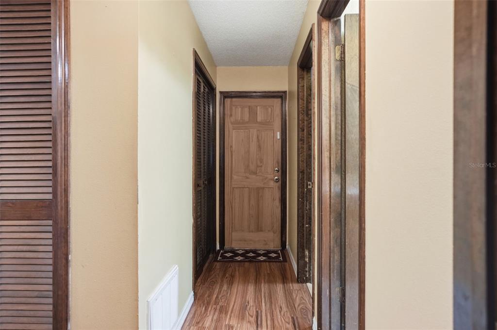 11286 Roland Street Spring Hill, FL 34609 - Photo 26 of 54 a view of front door with wooden floor