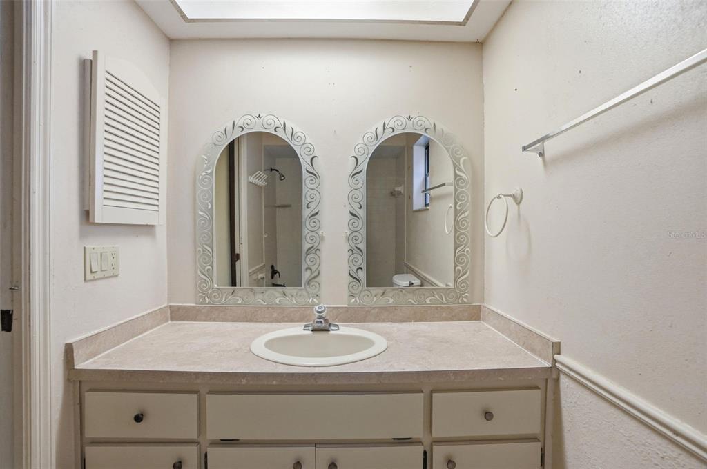 11286 Roland Street Spring Hill, FL 34609 - Photo 30 of 54 a bathroom with a sink and a mirror