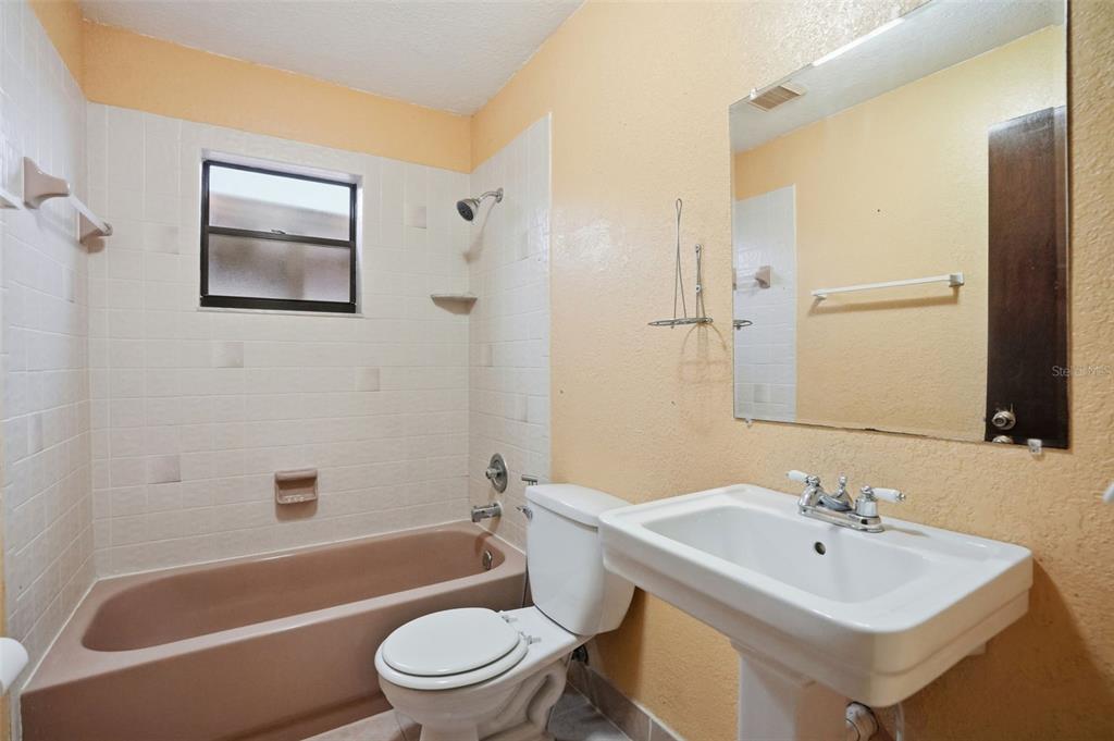 11286 Roland Street Spring Hill, FL 34609 - Photo 33 of 54 a bathroom with a sink a toilet and shower