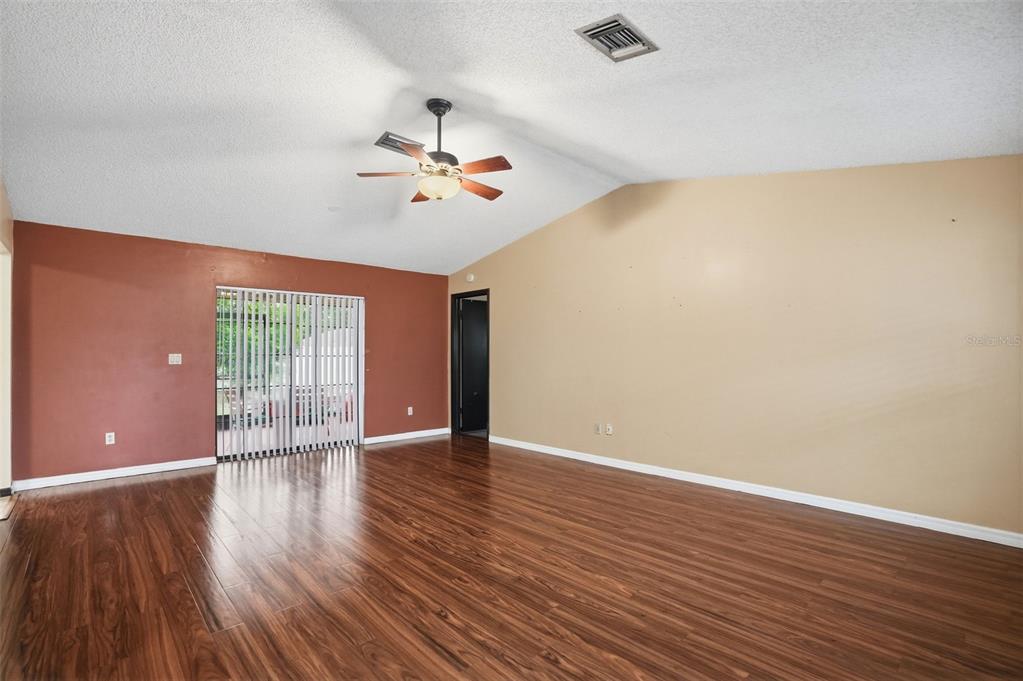 11286 Roland Street Spring Hill, FL 34609 - Photo 4 of 54 a view of an empty room with wooden floor and a window